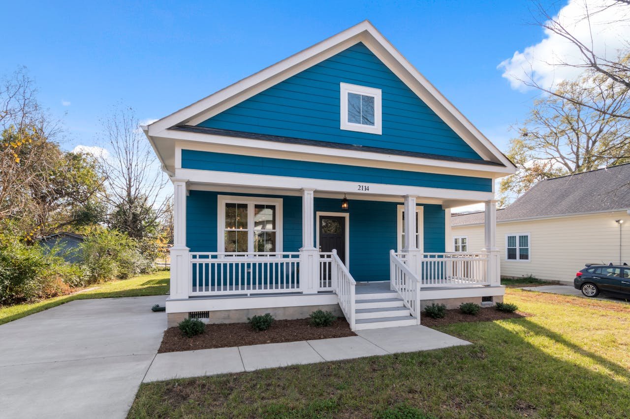 Exterior view of a blue suburban house with a welcoming front porch.